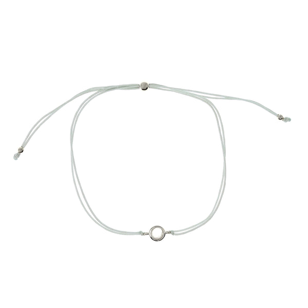 Delicate adjustable string bracelet featuring a moonstone set in a sterling silver bezel.