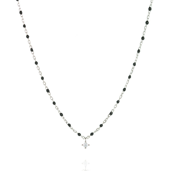 Sterling silver necklace with black beads and a central small cubic zirconia.