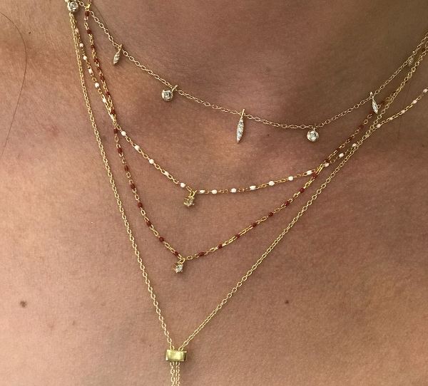 
Gold-plated necklace with red beads and a central Cubic Zirconia pendant.

