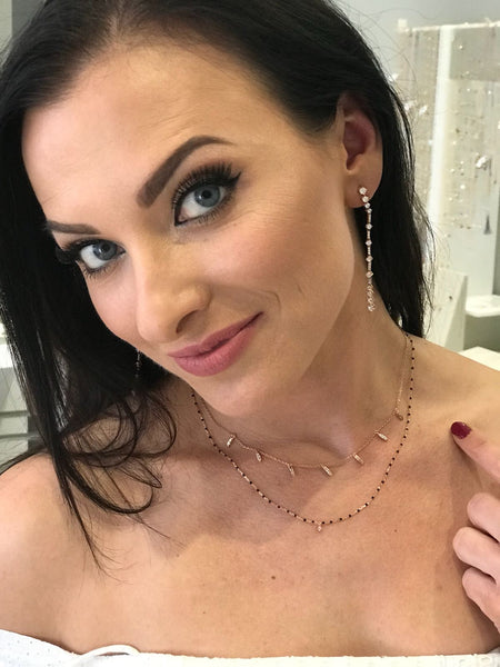 
Sterling silver necklace with black beads and a central small cubic zirconia.

